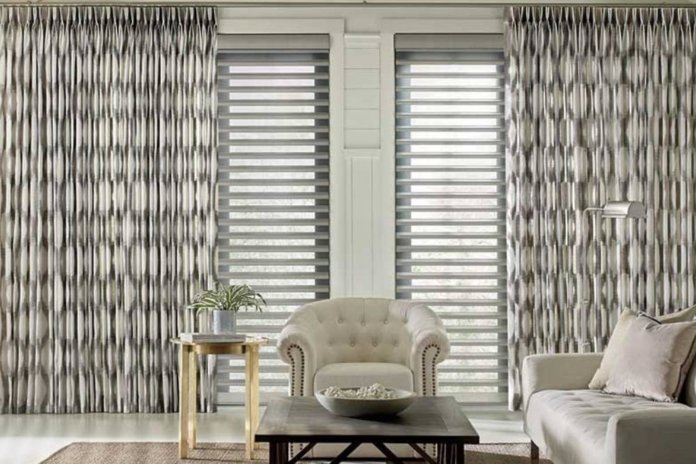 Living room with white sofa and round chandler. Curtains with a pattern hang in the background at Designer Furniture Gallery near Saint George, UT